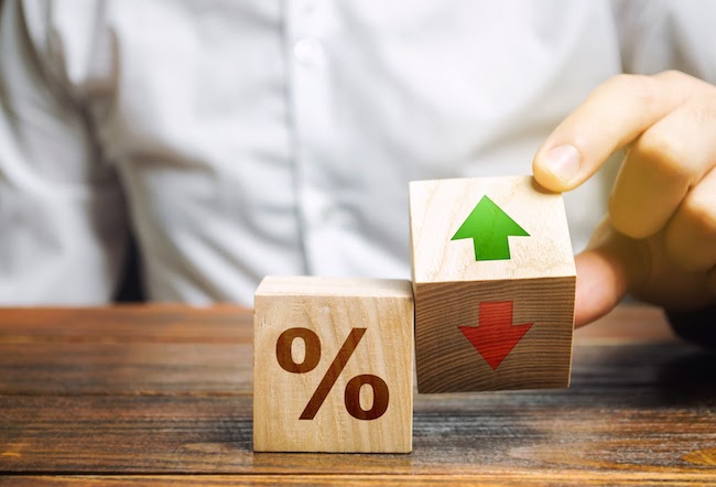 Kids blocks displaying an interest rate and up and down arrows