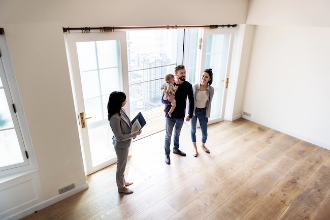 A couple looking at a home with a Realtor