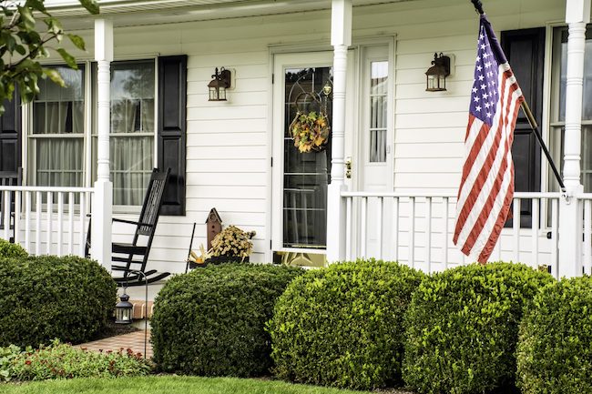 A white house with an American flag out front