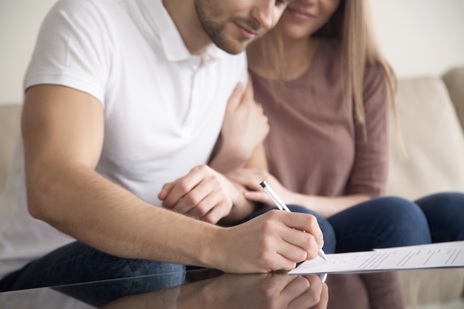 A couple signing a contract